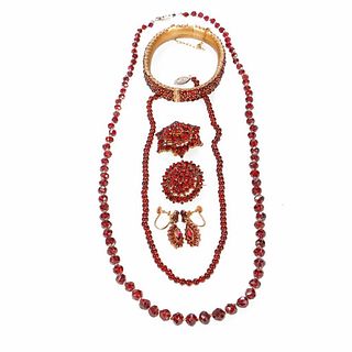 Collection of garnet and metal jewelry.