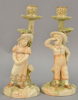 Pair of Royal Worcester figural candlesticks, boy and girl with hats, signed on base: Hadley, marked with pruple mark. ht. 10 1/4in.