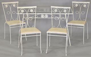 Wrought iron glass top table and four chairs.