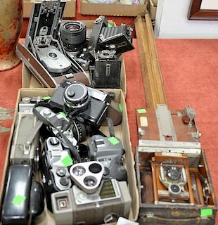 Group of vintage cameras and equipment to include Polaroid model 95B, Agfa, Kodex, Pentax cameras, Minolta 75, and Korona wood camer...