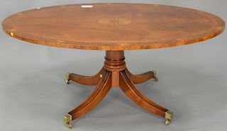 Oval inlaid mahogany coffee table with adjustable height pedestal. ht. 22in., top: 33" x 54"