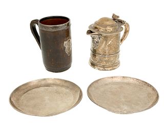 A group of silver and metal holloware table items