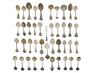 A group of silver souvenir spoons