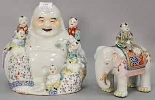 Two Oriental porcelain figural pieces including Budha with boys and an elephant having enameled flower rug and a boy on it. ht. 8 1/...
