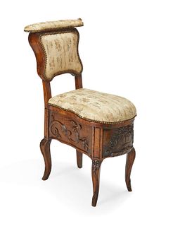 A French carved wood commode chair