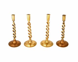 A group of English spiral brass candlesticks