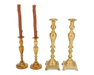 A group of brass candlestick holders