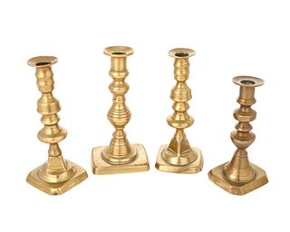 A group of brass candlesticks