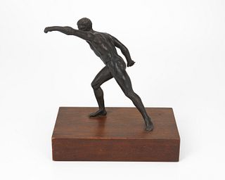 A bronze sculpture of an athlete