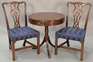 Kittinger three piece lot include two side chairs and a drum table with leather top. dia. 27in.