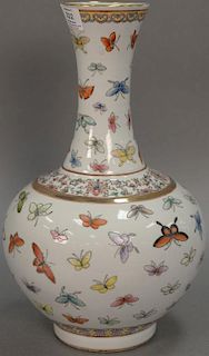 Oriental porcelain butterfly bottle vase having globular body with slender neck and flared rim ornately painted with butterflies. ht...