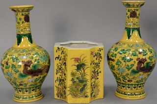 Three Famille Rose yellow ground Chinese porcelain pieces to include a pair of dragon vases and an octogon pot. vases: ht. 11 1/2",...
