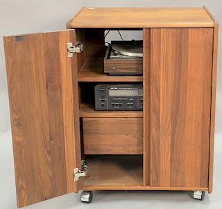 Teak music cabinet with dual turntable and Rotel AM/FM receiver.