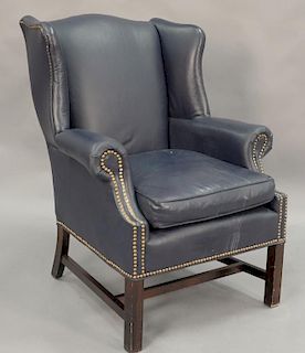 Chippendale style blue leather wing chair.