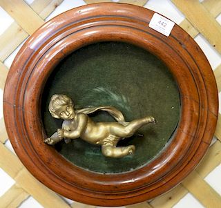 Bronze cherub mounted in round Victorian frame, dia. 15in.
