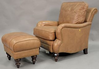 Brown leather chair and ottoman.