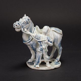 A BLUE AND WHITE STATUE OF HU PEOPLE LEADING A HORSE, QUAN DYNASTY