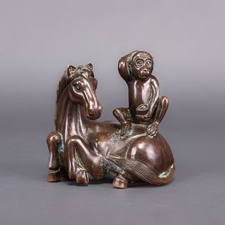 A BRONZE MODEL OF A MONKEY ON THE HORSE 