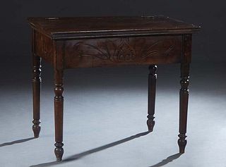 French Provincial Carved Walnut Petrin, 19th c., the hinged top over an incise carved skirt, on turned tapered cylindrical legs, H.- 31 in., W.- 36 1/
