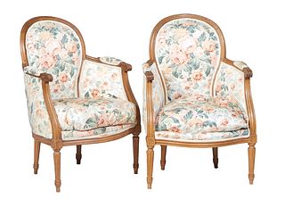 Pair of Louis XVI Style Carved Beech Bergeres, 20th c., the arched upholstered back to curved reeded upholstered arms, to a removable bowed cushion se