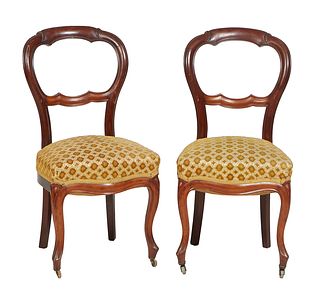 Pair of French Louis XV Style Carved Walnut Parlor Chairs, 19th c., the curved canted pierced back with a horizontal splat, to a bowed cushioned seat,