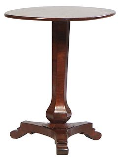 English Carved Mahogany Candlestand, the oval top on a tapered hexagonal baluster support to a tripodal base on scrolled feet, H.- 28 1/2 in., W.- 29 