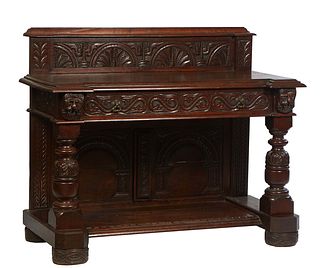 Continental Carved Oak Server, 19th c., the thick stepped leaf carved back over a stepped breakfront top with a large center frieze drawer, on Jacobea