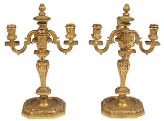 Pair of Gilt Bronze Neoclassical Four Light Candelabra, 19th c., with a central flame finial above four scrolled arms to classical relief decorated ca