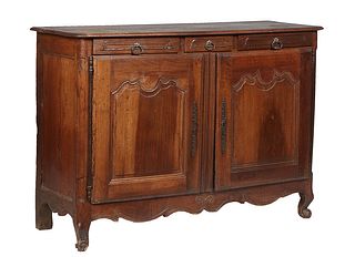 French Provincial Louis XV Style Carved Walnut Sideboard, 19th c., the rounded edge and corner three board top over three frieze drawers above double 