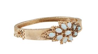 Lady's Vintage 14K Yellow Gold Hinged Bangle Bracelet, the tapering Florentine band mounted with eleven oval cabochon opals, H.- 7/8 in., Int. W.- 2 1