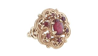 Antique Lady's 14K Yellow Gold Dinner Ring, with a central oval app. three carat garnet, atop a sloping lobed border with six round garnets, Size 9, W