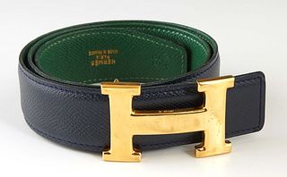 Hermes Constance H Belt, c. 1993, in emerald green and black Courchevel calf leather with gold hardware, L.- 25 1/2 in., W.- 1 1/4 in.