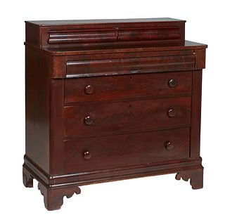 American Classical Carved Mahogany Chest, 19th c., the top with two setback glove drawers on a base with a cavetto frieze drawer, over three graduated