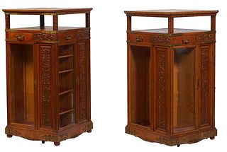 Pair of Aesthetic Carved Oak Revolving Bookmills, late 19th c., each of the four brass corner strapped sides with a drawer and a carved wood panel, ab