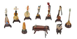 Collection of Ten Chinese Miniature Mixed Media Musical Instruments, 20th c., in carved jade and natural stone, including a violin, a sitar, and other