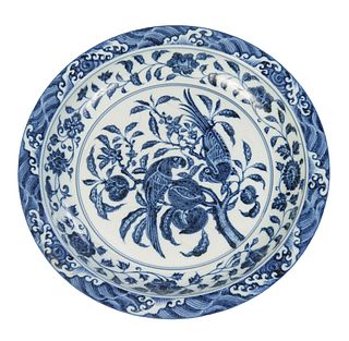 Large Chinese Blue and White Charger, 20th c., with an outer band of wave decoration, over a curved band with floral and leaf decoration around a cent