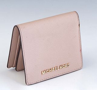 Michael Kors Mini Wallet, in light pink grained calf leather with golden hardware, opening to a matching pink lined interior with four card slots, two