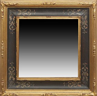 American Gilt and Gesso Mirror, the cove molded frame with ebonized sides, the corners with geometric tracery designs, around a wide beveled plate, H.