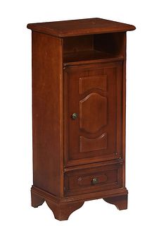 French Provincial Louis Philippe Style Carved Cherry Nightstand, 20th c., the rounded edge top over open storage, a long cupboard door and a bottom fr