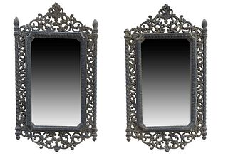 Pair of Renaissance Style Ebonized Mirrors, early 20th c., with a pierced floral crest flanked by flame topped pierced sides to a pierced bottom surmo
