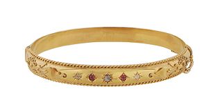 English 9K Tellow Gold Hinged Bangle Bracelet, c. 1900, the relief top with three small diamonds separated by two round rubies, with a safety chain, H