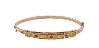 English 9K Yellow Gold Hinged Bangle Bracelet, c. 1900, the tapered top mounted with three round rubies separated by tiny round diamonds, H.- 1/4 in.,