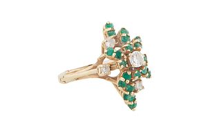 Lady's 14K Yellow Gold Dinner Ring, of elongated sloping form, with a central 20 point round diamond, atop a border of 20 round emeralds, and four sma