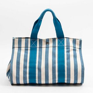Hermes Cannes GM Handbag, in blue and ivory stripped canvas with silvered hardware, opening to a matching stripped interior with an attached blue stor