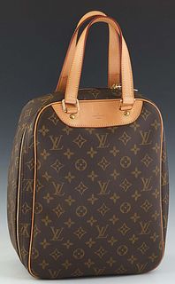 Louis Vuitton Excursion Handbag, in brown monogram coated canvas with vachetta leather accents and golden brass hardware, opening to a beige coated ca