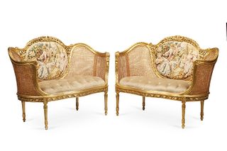 A pair of French caned settees