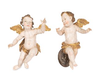 A pair of carved wood polychromed Putti