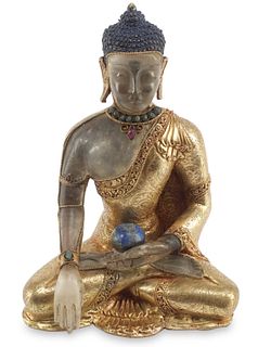 A Chinese gilt-bronze and rock crystal seated Buddha
