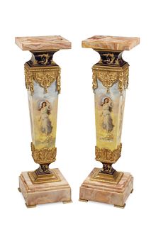 A pair of French onyx and porcelain pedestals