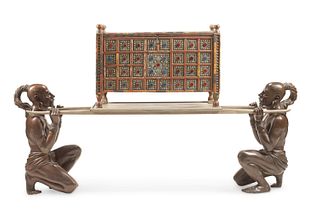 A carved wood chest with bronze figural supports